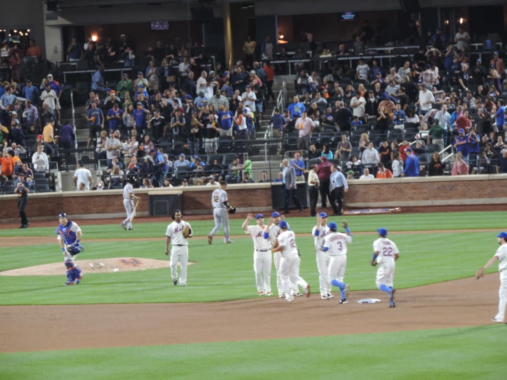 a group of baseball players walking across a field