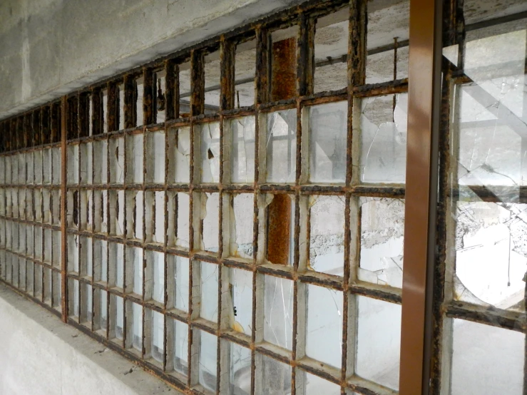 a very old and dirty looking window in the middle of an abandoned building