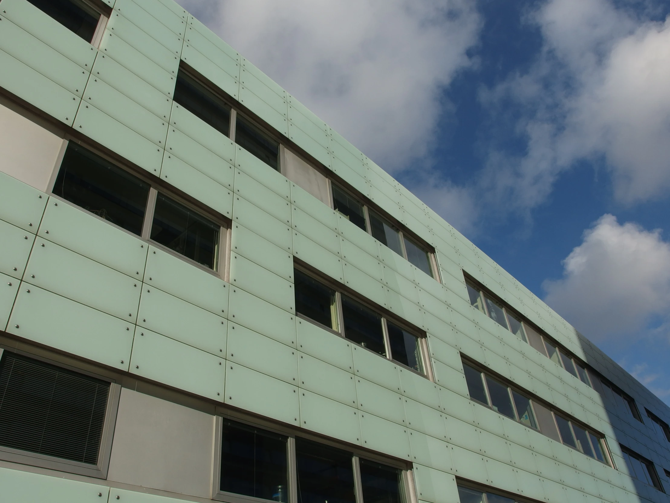 the corner of a building with windows on the side