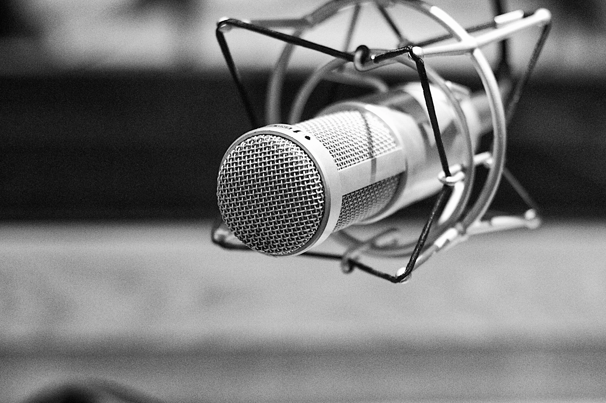 a microphone sits on a table and is black and white