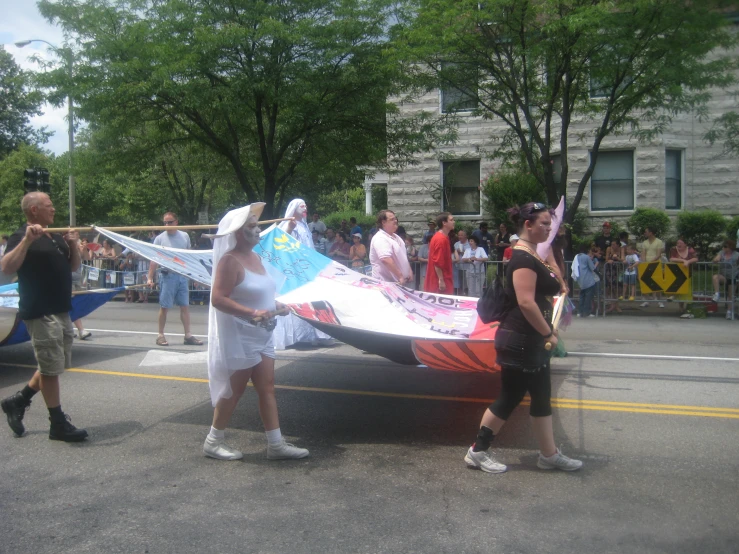 two women dressed in costume holding a kite