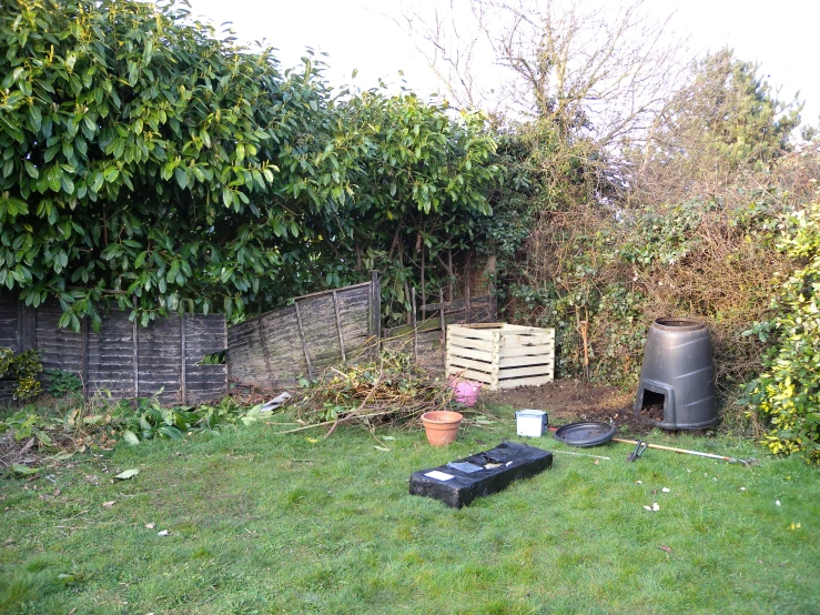 a back yard area with some large plastic containers
