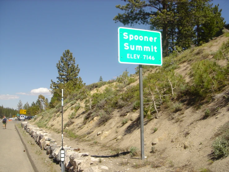 a street sign that says spooner summit fly'thru