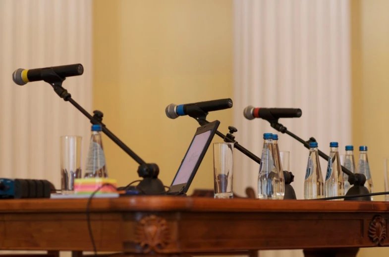 there are microphones on top of a desk