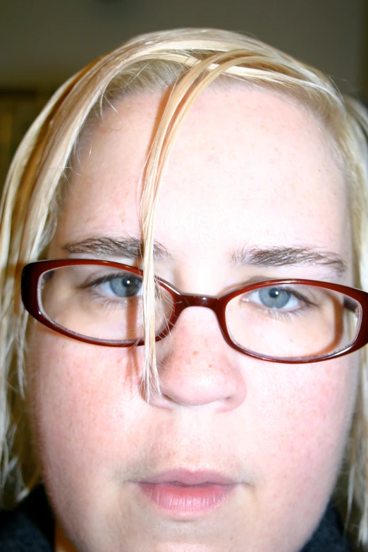 a woman with glasses and long blonde hair