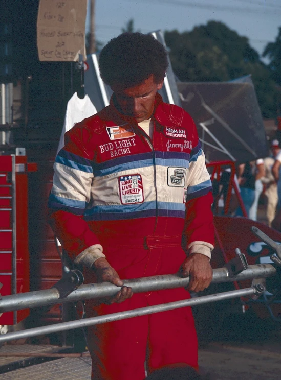 the racer stands on the side of the track looking back