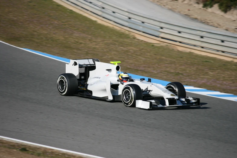 a man driving a race car on a race track