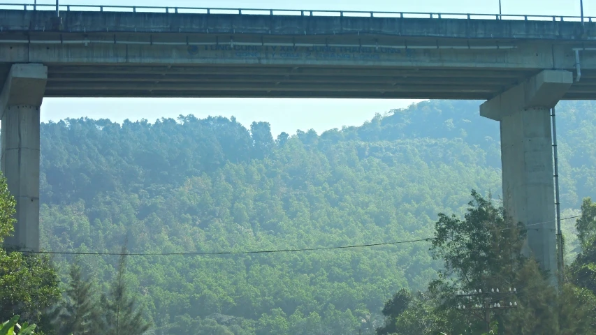 two people on a raft float under a bridge