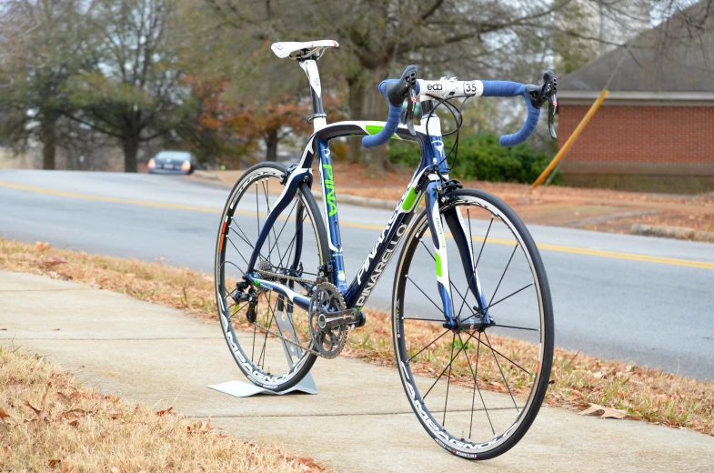 a bike parked next to the curb next to a street