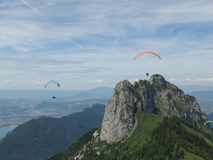 two paragliders flying over the mountains