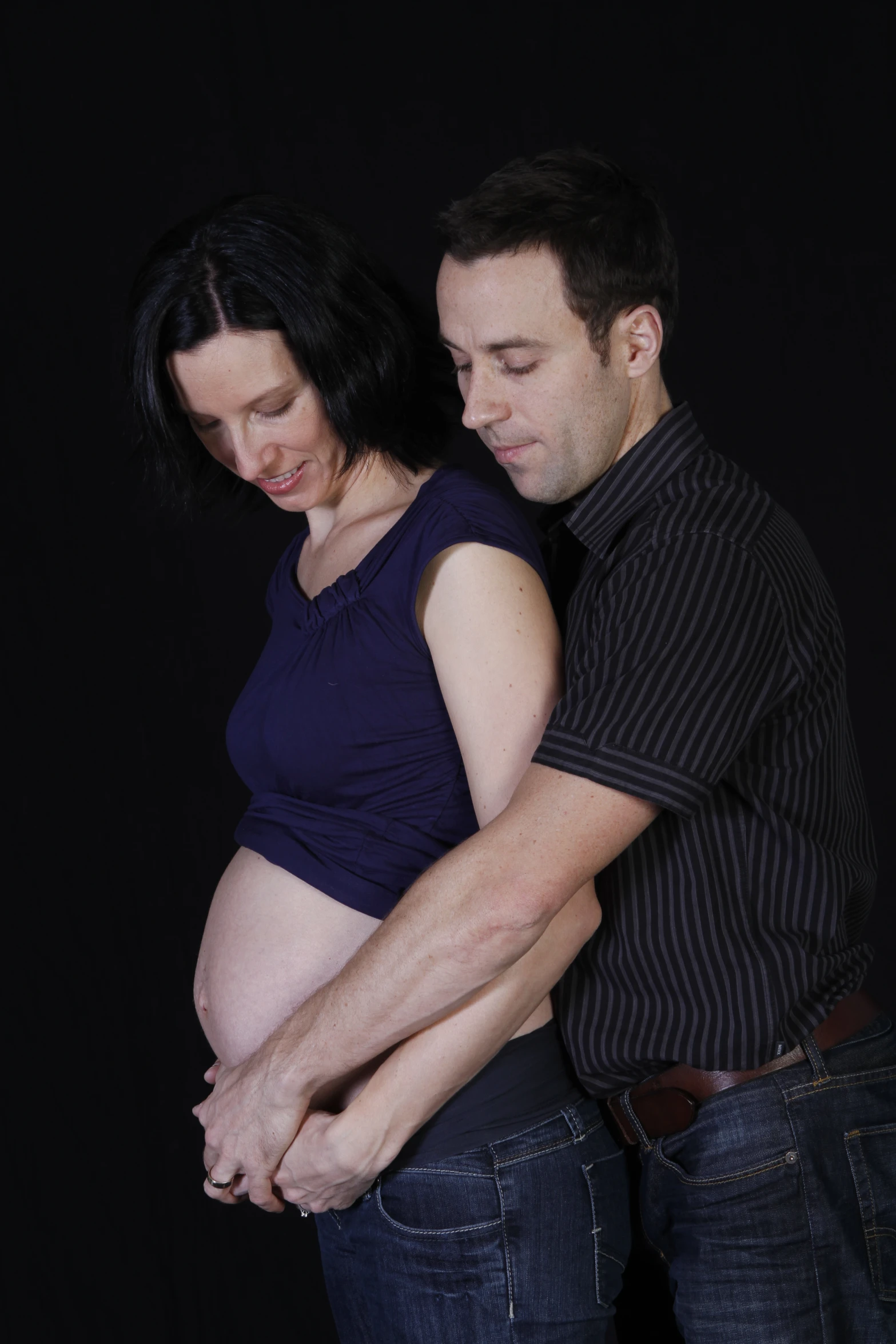 a man and woman are holding their stomachs