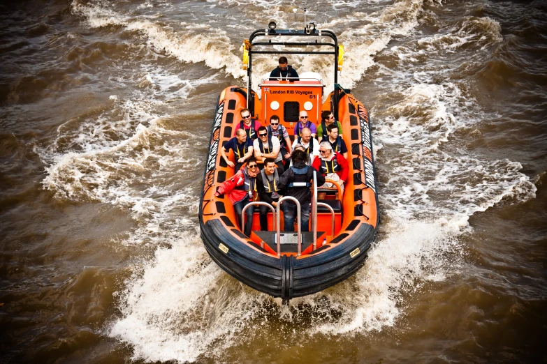 the raft is full of people riding through the water