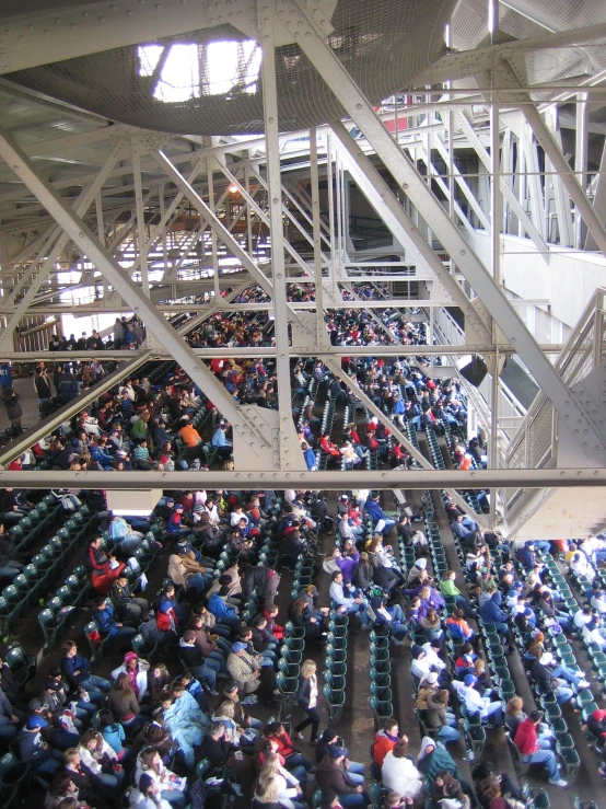 several people are sitting and talking in a stadium