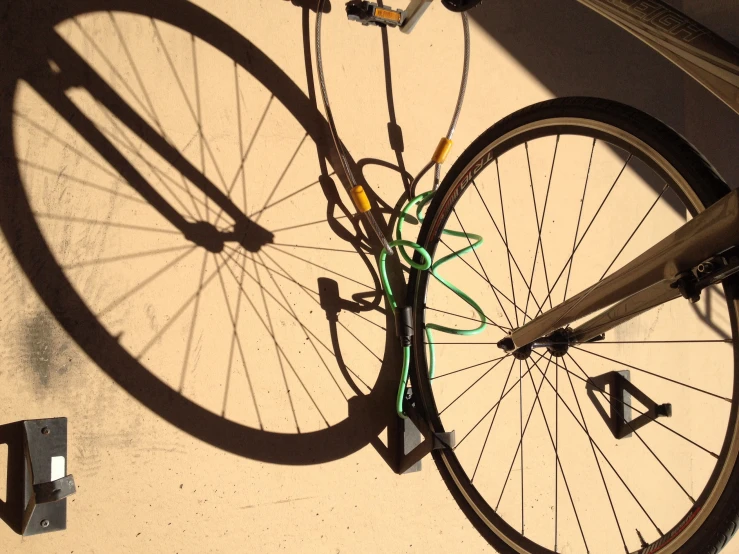 a bicycle is suspended on the side of a building