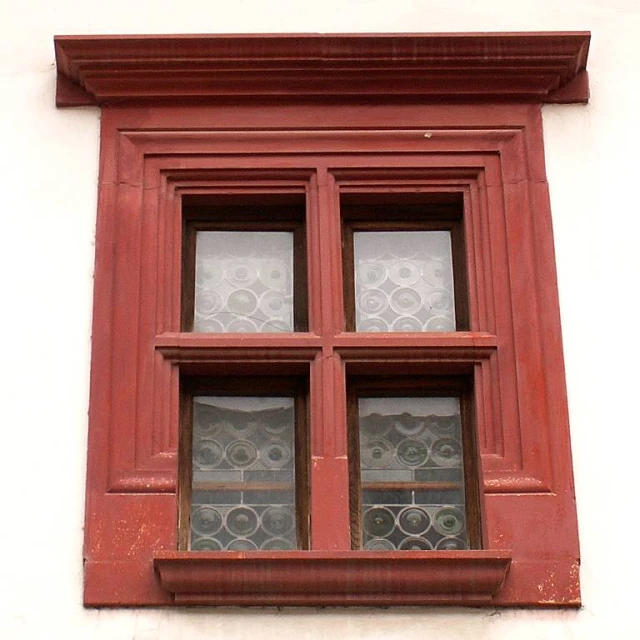 red windows with circular designs are on the building