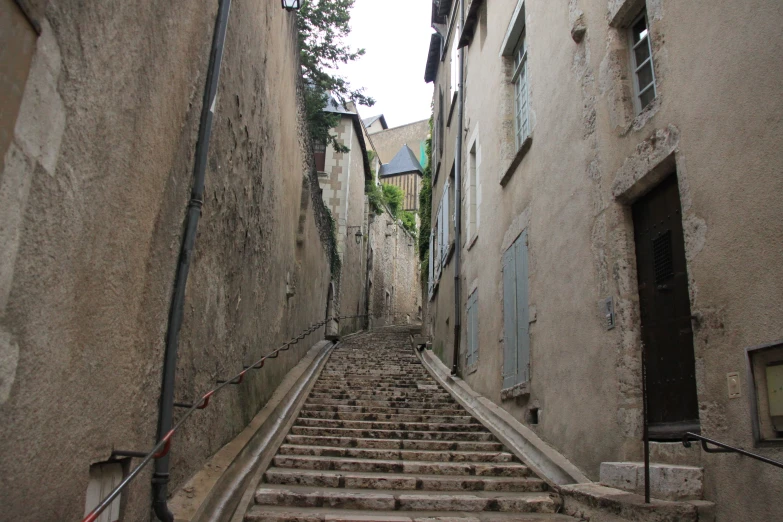 an old alley with stairs leading to various buildings