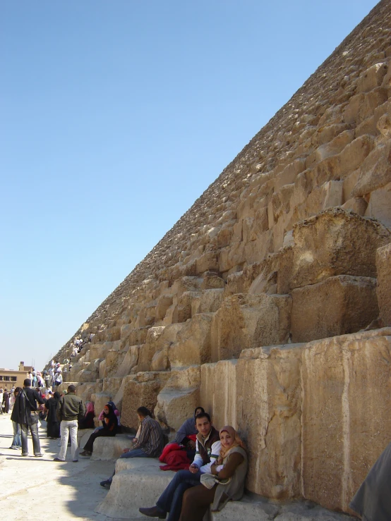 people sitting in front of the great pyramid of giza