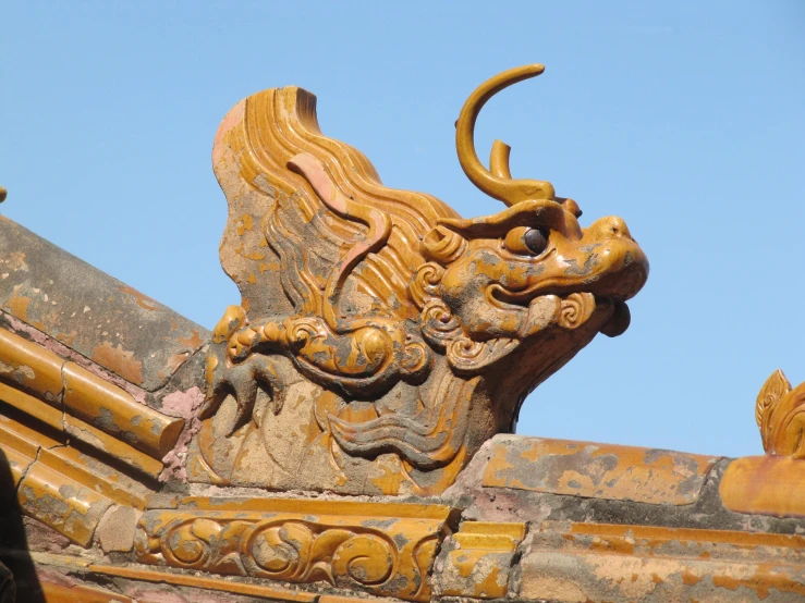 an ornate wooden dragon is on display at a museum