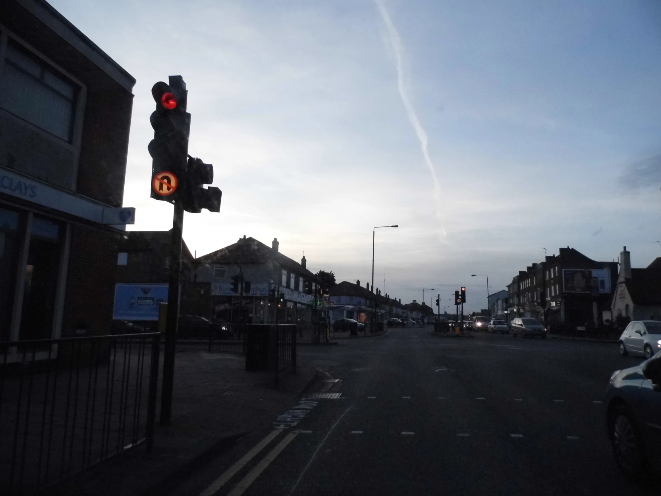 the view of an intersection with traffic lights in the distance