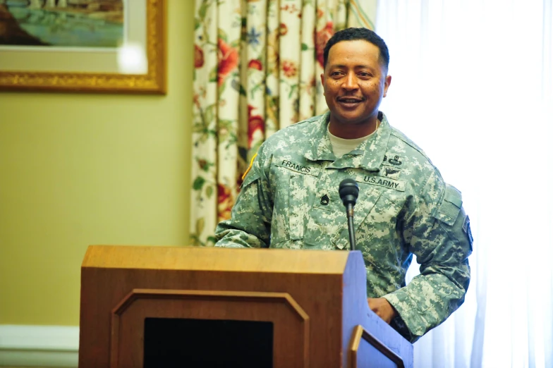 military man speaking from podium in room