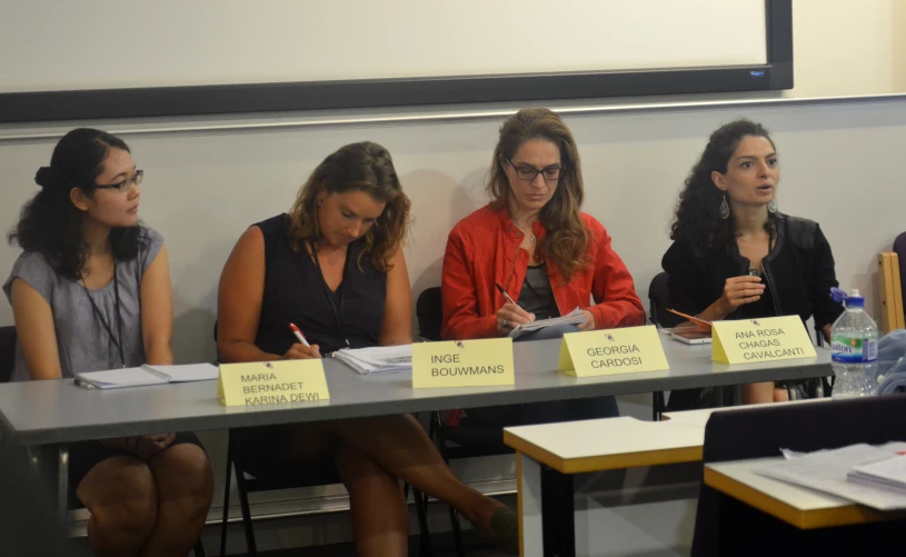 three women at table with notes and pens