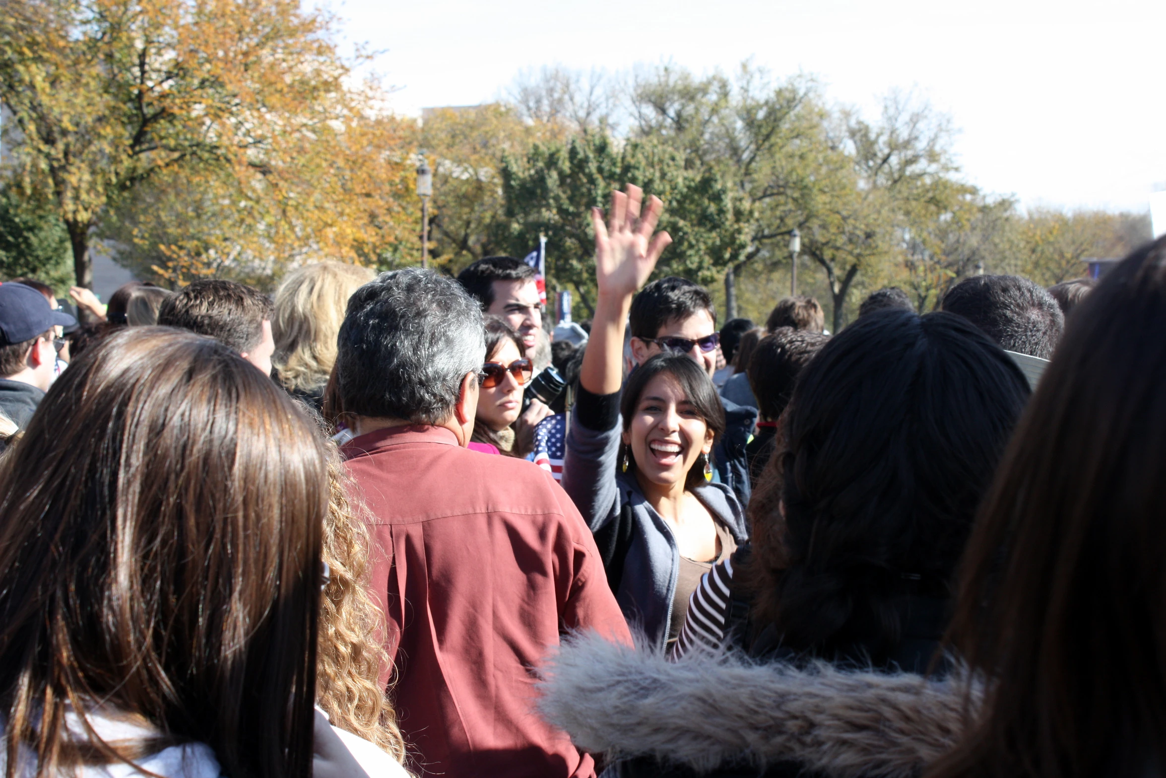 a group of people are standing with one hand raised