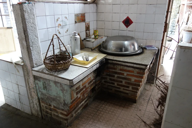 a kitchen area that includes a sink and brick