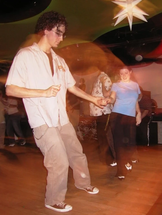 two people are standing in front of a star and holding hands