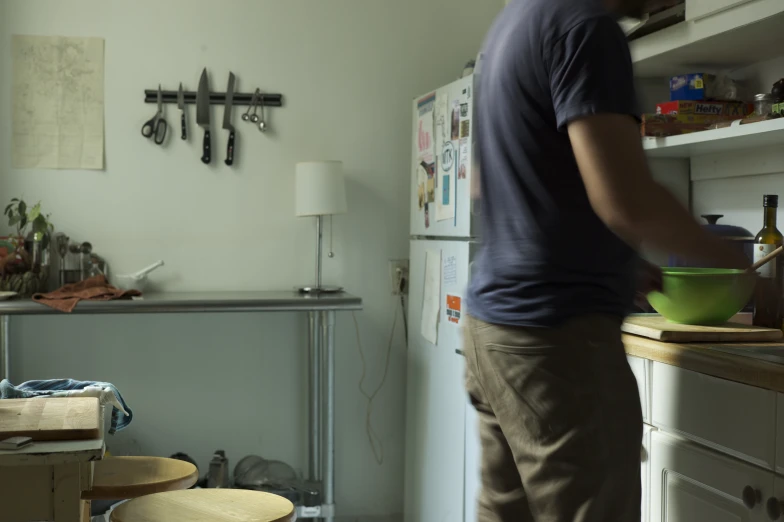 a man is standing in the kitchen and working on the work