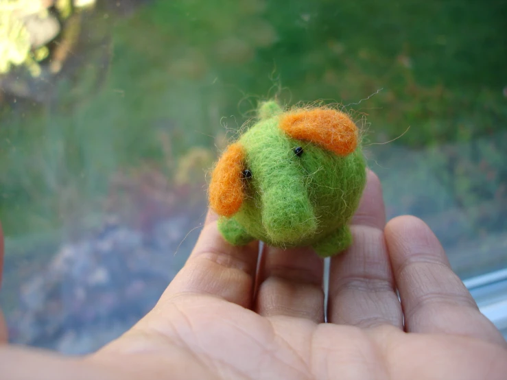 a tiny toy animal that is sitting in a hand