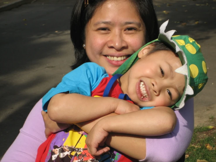 a woman holding a child with a costume on