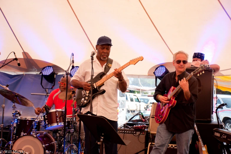 a band of people play music on stage