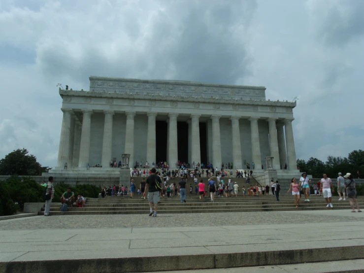 a lot of people standing in front of the lincoln memorial