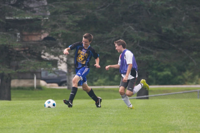 two men are playing soccer in the field