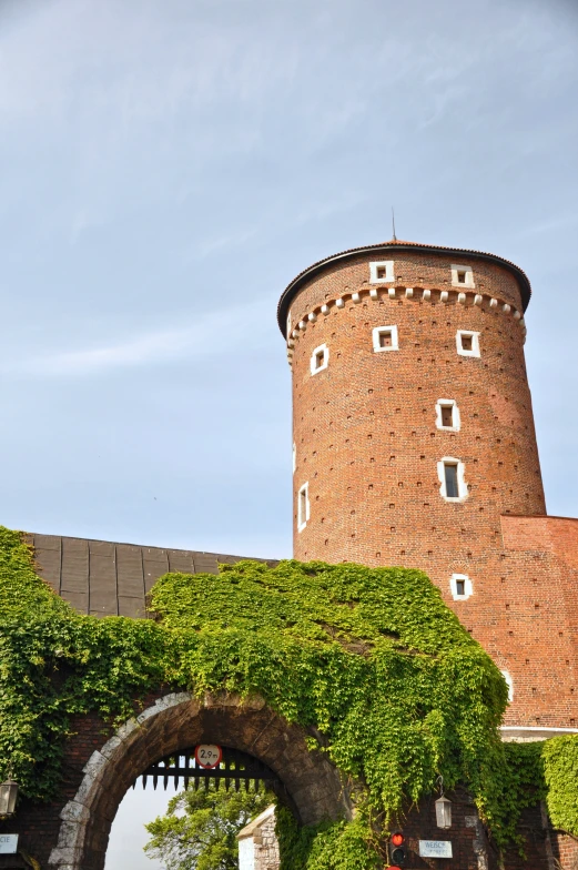 an archway between two brick buildings with a clock on it