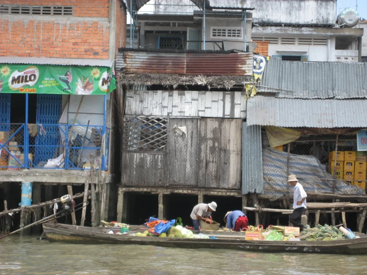 people on the river outside of old buildings