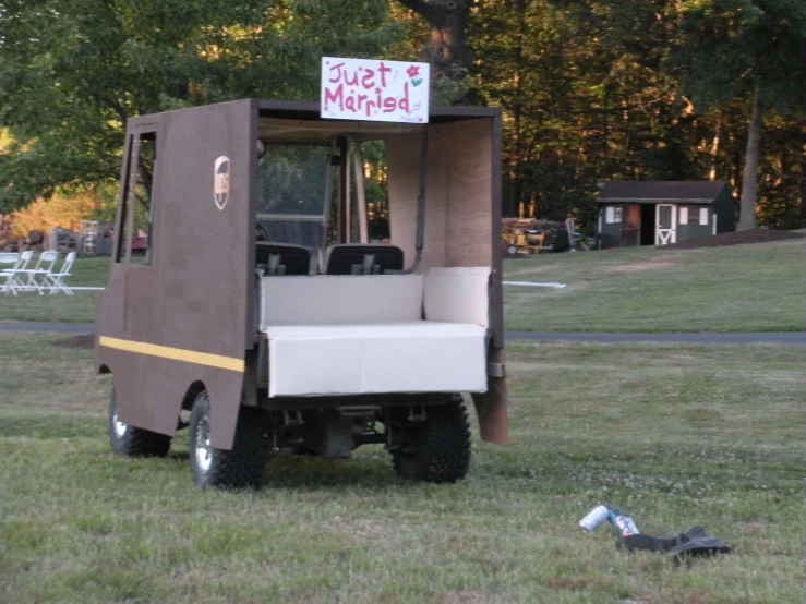 a person is sitting in the back of an ice cream cart with a bed