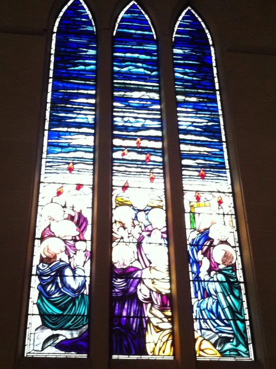 a stained glass window inside of a white church