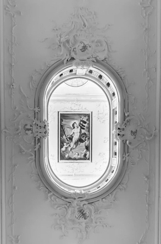 a black and white po of an ornate mirror