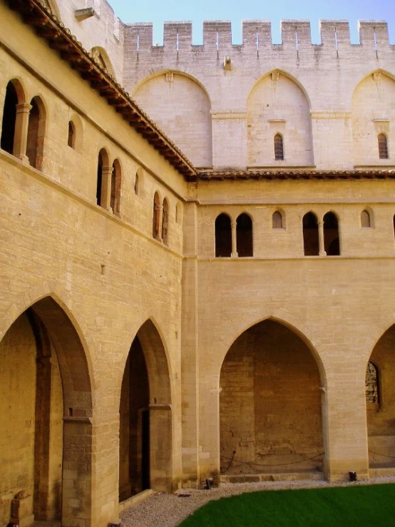 a courtyard at a castle with arches and a clock