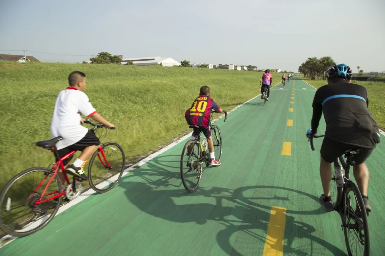 cyclists are riding down the country road on their bikes