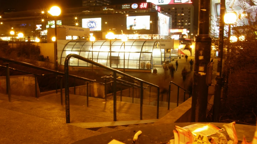 a public stair way with bags of trash at night