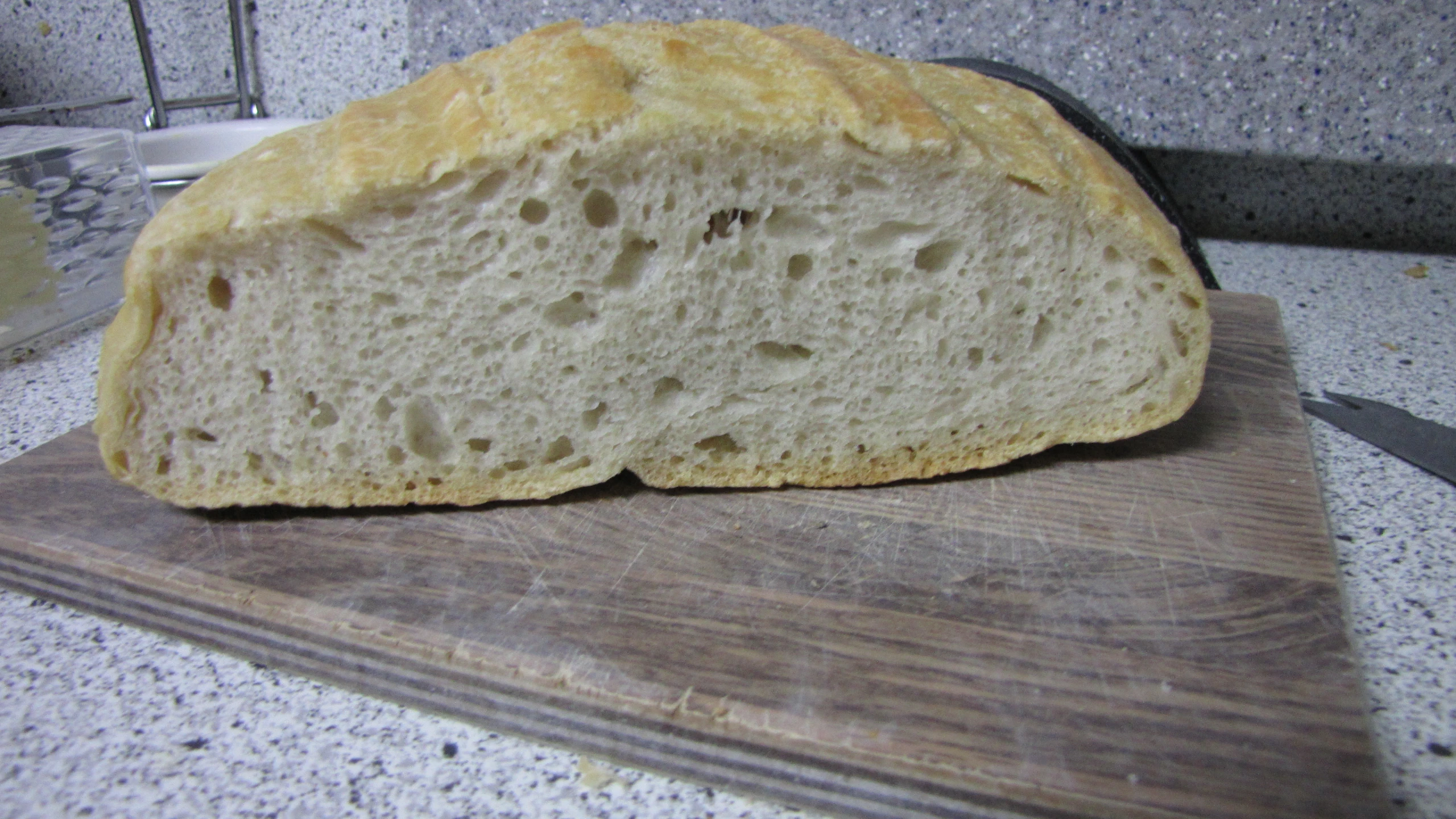 a piece of white bread sitting on top of a  board