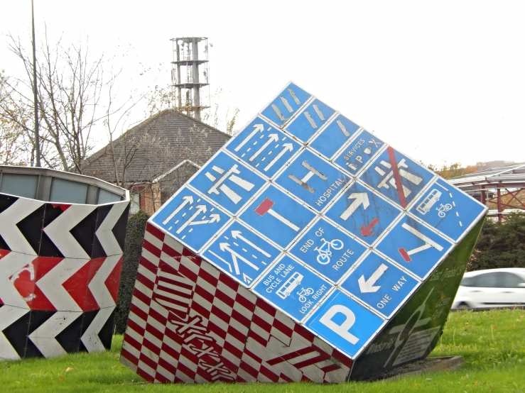 a couple of colorful sculptures sitting on top of a lush green field