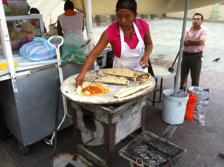 the woman is preparing food on a big table