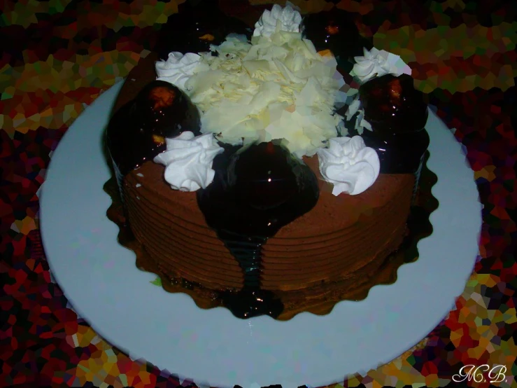 chocolate cake with flower decoration on top sitting on table