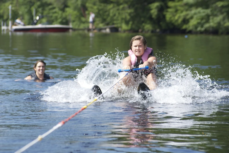 a woman is being towed on a water ski