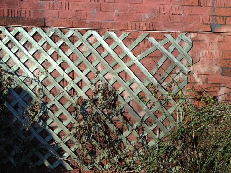 a fence on a building in front of a brick wall