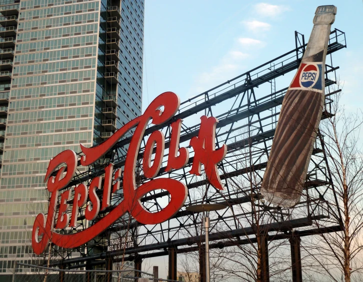 a coca cola sign and giant sign displayed in front of a building