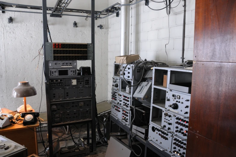 the old control room has an assortment of wires and electrical equipment